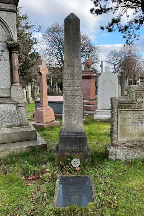 The memorial to Robert Smith in Dean Cemetery is a grey obelisk in among the graves 