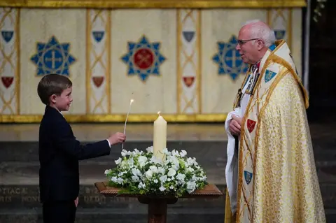 Aaron Chown/PA Media Alexander Churchill, 10, lights the VE Day 80th Candle of Peace during a Service of Thanksgiving at Westminster Abbey in London on the 80th anniversary of VE Day. Picture date: Thursday May 8, 2025.
