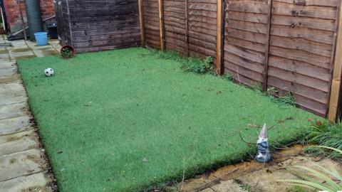 A small patch of fake grass in the victim's back garden