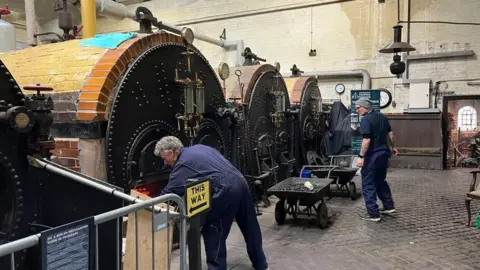 Volunteers working in the boiler room