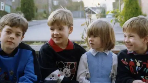 Family handout Four young children next to each other in an old photo.