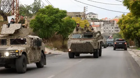 Reuters Lebanese army soldiers drive in Qana, southern Lebanon, after the start of the ceasefire (27 November 2024)