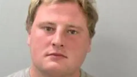 West Mercia Police A man with blonde hair in front of a grey background