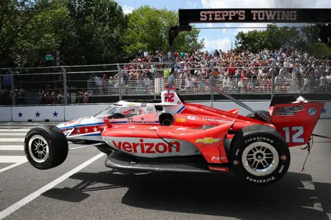 Getty Images The #12 Verizon Team Penske Chevrolet of David Malukas is carried out after a crash in the NTT INDYCAR Series on August 23, 2026 in Washington, DC.
