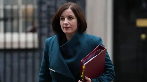 Education Secretary Bridget Phillipson, wearing a coat and carrying a red folder, leaves 10 Downing Street following a cabinet meeting