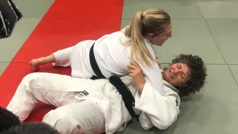 Jonathan Park/BBC Emma Reid practising Judo with her mother Lesley