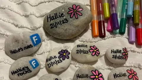 PA Media pebbles painted and with flowers and name Hallie