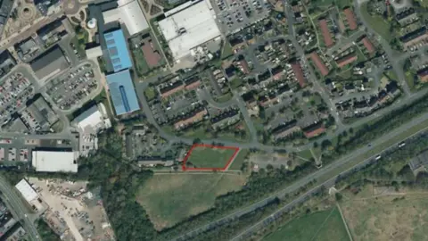 LDRS Looking down onto a parallelogram-shaped patch of green land in Spennymoor. The patch has been identified for the development.