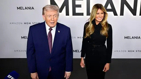 Getty Images Melania in a black suit and Donald Trump in a blue suit appear at the film's premier. 