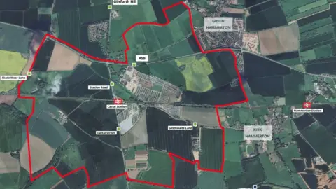 A map of the proposed development area showing the villages of Kirk Hammerton in the bottom left and Green Hammerton at the top right with a red symbol showing Hammerton Station to the right-hand side. There is a red line showing where the proposed development would be built with a red symbol showing Cattal Station in the centre.