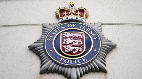 The States of Jersey Police badge outside the police station in St Helier