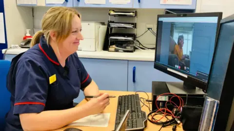 BBC A nurse looking at a monitor