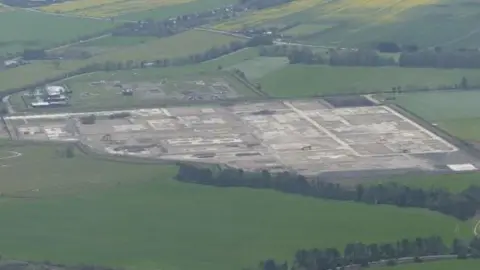 Aerial view of the former gas terminal surrounded by fields and trees