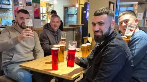 Gedling Sarai a table of men with some beer and cider