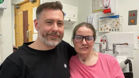 Jamie Coulson/BBC News Mr Clarke and Ms Ellis in hospital room