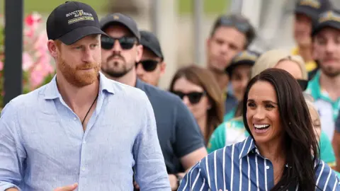 Prince Harry, Duke of Sussex and Meghan, Duchess of Sussex greet members of the public.