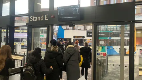 A picture of passengers aboard 203 bus services at Stockport Interchange.