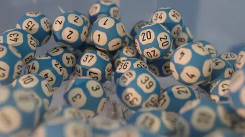 Lottery balls in a container awaiting a draw.