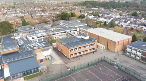 North Yorkshire Council An image of a large collection of school buildings with sports facilities in front of the buildings