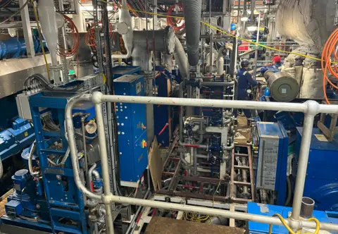 BB A machinery space for a ship which is full of pipework
