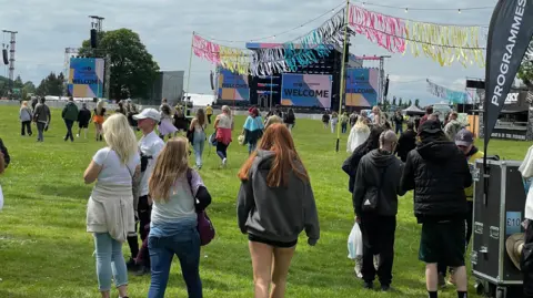 Danny Fullbrook/BBC The backs of crowds walking into Radio 1's Big Weekend