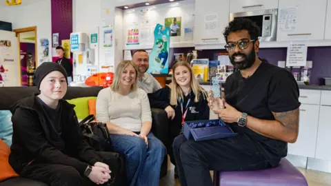 Teenage Cancer Trust Logan, 13, mum Nicola, dad Jon and Faye Hindmarsh with Romesh Ranganathan.