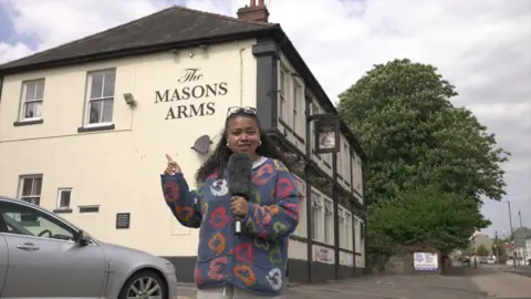 BBC reporter Lena-Zaharah Mohammed stands outside the Mason Arms 