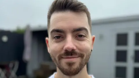 Man with beard smiling into the camera