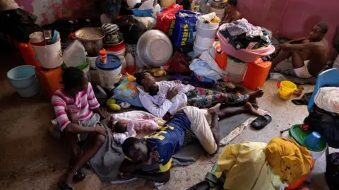 Reuters People displaced by gang war violence stay in a shelter in Port-au-Prince, Haiti. Photo: May 2024