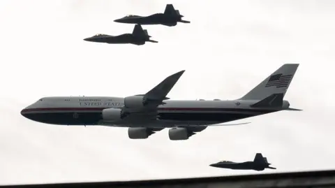 EPA F22 Raptor fighter jets escort the new version of Air Force One as they fly over the National Mall during the Salute to America Semiquincentennial celebration in Washington
