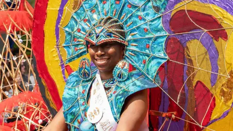 Preston City Council handout A woman dressed in a vibrant multi-coloured outfit at the Caribbean Carnival Festival.