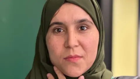 Alice Cunningham/BBC Close up of Meena Nouri. She is wearing a karki