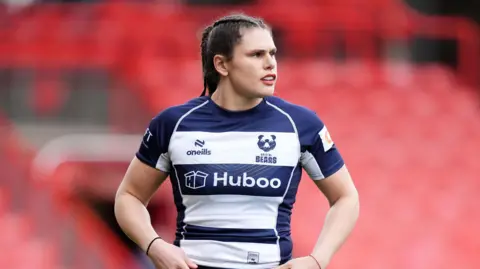 Ilona Maher standing on the pitch during a game for Bristol