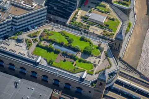 jasonhawkes.com Rooftop green garden above railway station with train carriages poking out