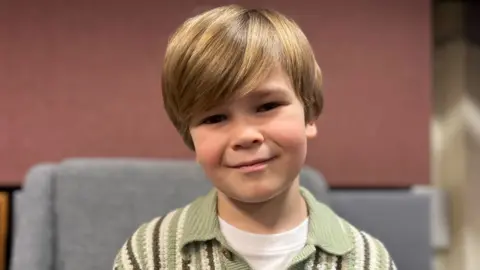 Fred sitting in a grey chair