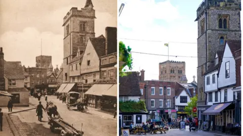 St Albans Museums/KL Creative Photograph This image shows two views of the same thing, years apart, the left is a sepia image from about 1918, the right is a colour photograph from the 21st Century. Both show The Boot pub on the left, the Clock Tower on the right and the cathedral tower in the distance, plus neighbouring shops and members of the public in the market place.