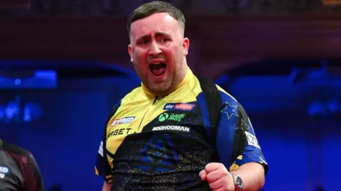 Luke Littler celebrates his nine-darter at the Winter Gardens in Blackpool