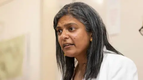 Nicola Tree/Getty Images Rupa Huq wearing a white blazer and a Labour rosette