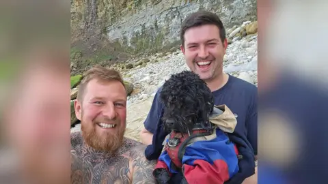 Joe Brain Truffle the dog with his rescuers