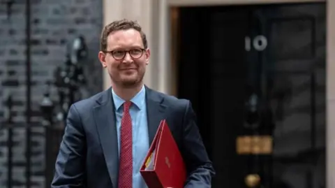 AFP via Getty Images Darren Jones in Downing Street, with the No 10 door behind him