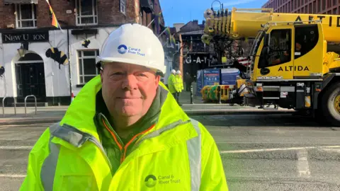 Photograph of Stephen Foulds from the Canal and River Trust. The 59 year-old is pictured beside Canal Street in Manchester's Gay Village.