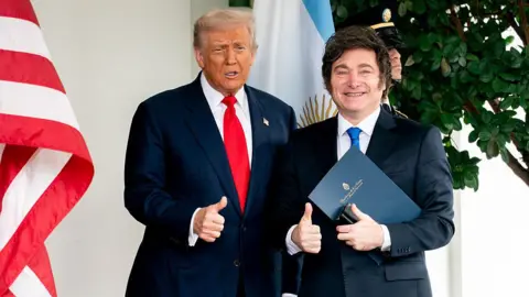 US President Donald Trump, left, and Javier Milei, Argentina's president, smile with their thumbs up outside the West Wing of the White House in Washington, DC, US, on Tuesday, Oct. 14, 2025, shortly after the US agreed to extend financial support for the Argentine peso. 