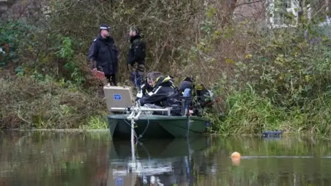 PA Media Divers and police officers at the River Wensum in the search for Gaynor Lord. 