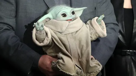 Getty Images Chilean-US actor Pedro Pascal holds a Grogu as they pose on the red carpet upon arrival to attend the UK fan event for 'Star Wars: The Mandalorian and Grogu' at Cineworld Leicester square, central London of May 7, 2026.