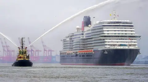 PA Media Cunard cruise ship the Queen Anne is escorted by a tug boat on the River Mersey