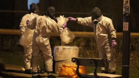 PA File photo dated 13/03/18 of personnel in protective suits working in the Maltings shopping centre in Salisbury, where former Russian double agent Sergei Skripal and his daughter Yulia, were found critically ill by exposure to Novichok nerve agent.