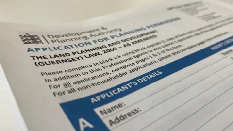 BBC A Development and Planning authority application. It is blue and white. It features a table to fill out application details.