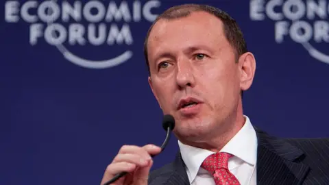 Getty Images  Jahangir Hajiyev speaking into a microphone at the World Economic Forum 