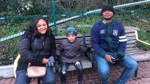 Sue Agazie, her son and her husband