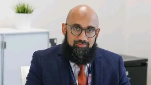 Supplied A man with a beard in a suit and tie